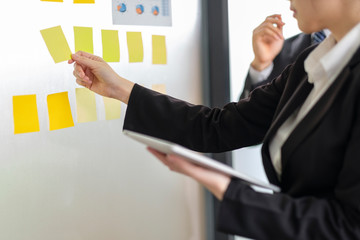 Businessman holding a chart and tablet at meeting room.Business concept