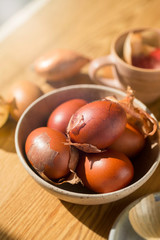 Bowl of  eggs dyed red in onion skins. Polish Easter tradition. Sustainable natural dye.