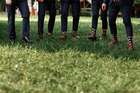 stylish men's socks. Stylish suit, men's legs, multicolored socks and new shoes. Concept of style, fashion, beauty and vacation. selective focus. copy space