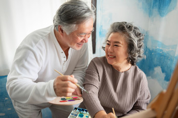 Happy smiling Asian Elderly Couple oil painting on canvas at house.