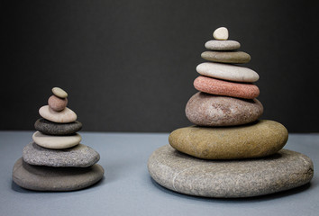 Fototapeta na wymiar The composition of stones characterizes leadership movement forward and up two options