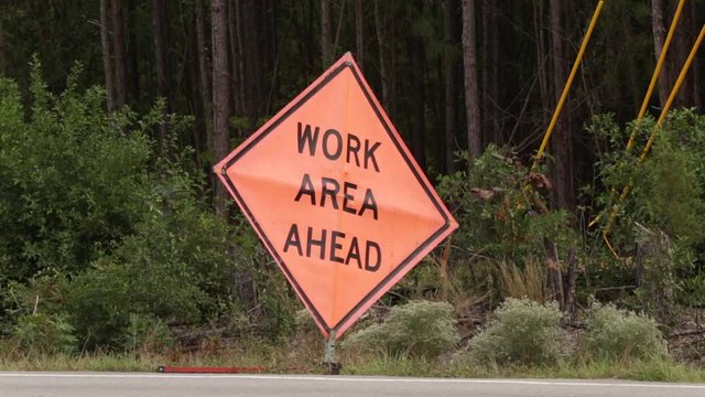 Construction Work Ahead Sign on side of the road