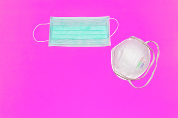 Obraz premium Protective mask and virus spread on pink background with inscription CORONAVIRUS COVID-19.