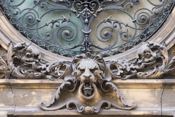 Elements of architectural decorations of buildings, sculptures and statues, public places in Lviv, Ukraine. Sculpture of lion head on the window