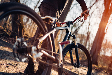 Boy is preparing to ride his bike through the forest