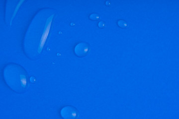Serum smear smudge swatch with collagen and peptides on blue background. Skin care gel transparent sample drop with bubble. Emulsion texture. Anti aging woman beauty cosmetic product. Macro