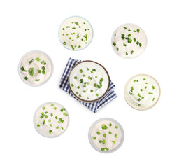 Set of delicious sour cream with onion in bowls on white background, top view