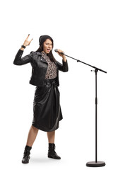 Fototapeta premium Female singing and gesturing rock and roll sign