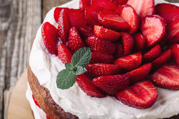 Homemade sponge cake with strawberries and cream