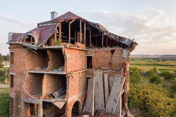 Old ruined building after earthquake. A collapsed brick house .