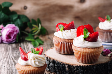 Homemade cupcakes with strawberries and cream