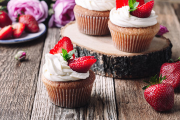 Homemade cupcakes with strawberries and cream
