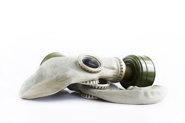 two old soviet gas masks on a white background. concept of peace and war. a means of protection...