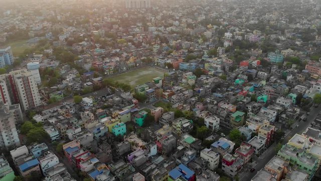 Dense indian city buildings at kolkata drone footage aerial view. slums of india at sunset.