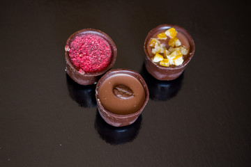 Various of sweet confectionery with chocolate candies and pralines. Handmade box of chocolates. Realistic chocolate set, delicious dessert pattern.