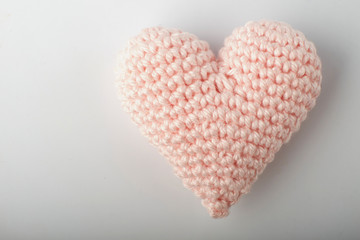 A close up image of metal crochet hooks and crochet cotton dish cloths.