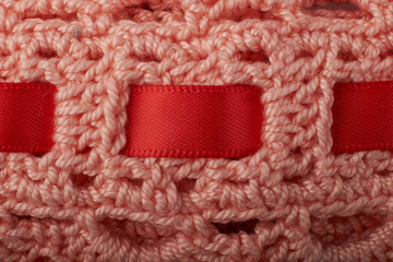 A close up image of metal crochet hooks and crochet cotton dish cloths.