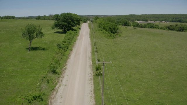 Aerial shot of a dirt road in the countryside