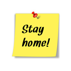 Stay home message on yellow note paper pinned to wall.