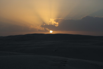 The sunset on the white dunes of the Al Khaluf Bay, Oman