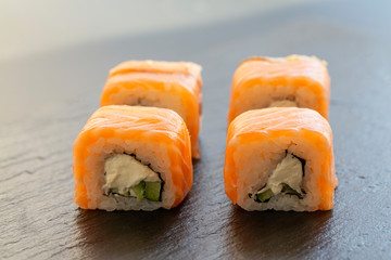 Philadelphia roll classic. Salmon, Philadelphia cheese, cucumber, avocado. Japanese sushi. 