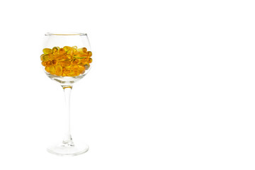 Blurred background of a glass with yellow pills.