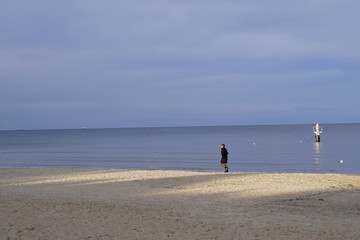 Fototapeta premium A man walking on the beach