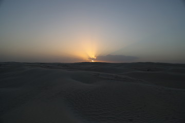 Fototapeta na wymiar The sunset on the white dunes of the Al Khaluf Bay, Oman