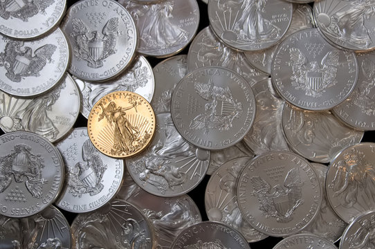 Layout of American Eagle silver dollars and a one ounce gold coin