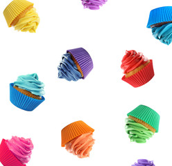 Set of falling delicious birthday cupcakes on white background