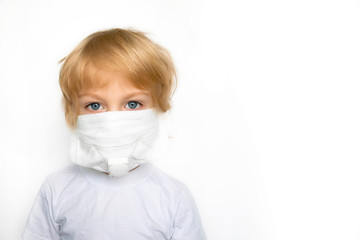 Little boy in a white medical mask on a white background.