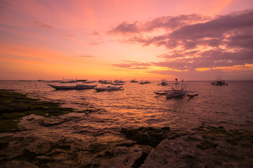 Fototapeta na wymiar Colorful sunset on the Apo island of the Philippines.