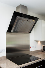 modern high standard kitchen with hob and extractor 