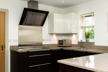 modern high standard kitchen with hob and extractor 