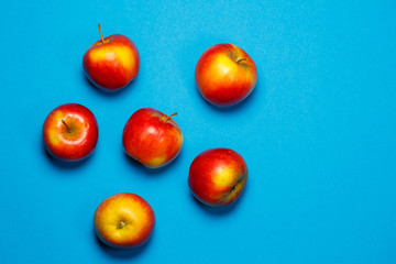 red-yellow juicy apples on a blue background. Healthy Nutrition and Vitamins