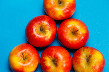 red-yellow juicy apples on a blue background. Healthy Nutrition and Vitamins