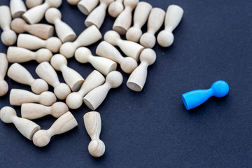 Personal development. Wooden figure in a crowd. Think different.