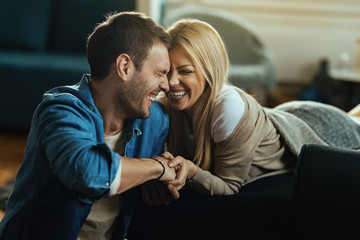 Young couple having fun and laughing while spending time at home.