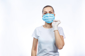 woman health worker demonstrates how to wear a protective medical surgical mask against the virus. Isolated on white background