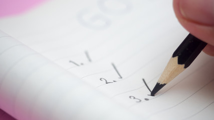 Black marking on checklist box with hand write pencil close up. Checklist concept