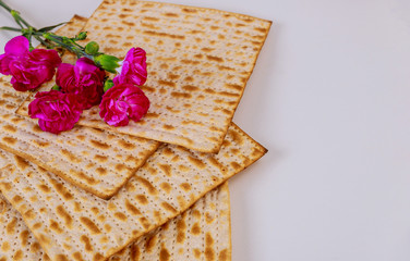 Israel matzah bread with pink flowers. Jewish Passover holiday concept.