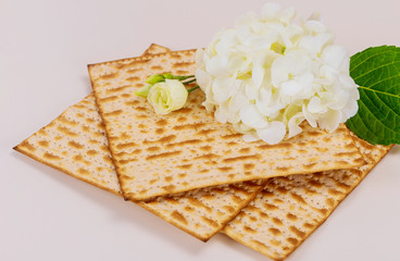 Matzah bread with white flowers. Jewish Passover holiday concept.