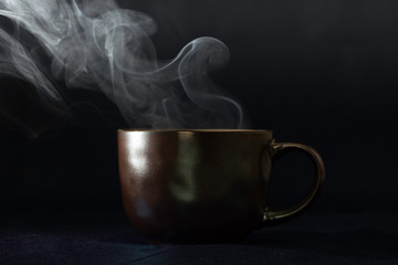 Fototapeta premium steaming cup on black background