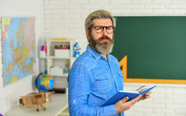Cognitive development. Teacher work at college. Education concept. Literature and poetry. Back to school. Bearded man reading book. Inspiring to learn. Modern school. Private lesson. School project