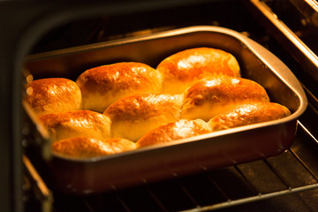cakes on a baking sheet in the oven, ready