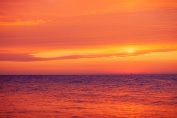 beautiful red-orange sunset on the sea, colorful sky and sea, magical landscape