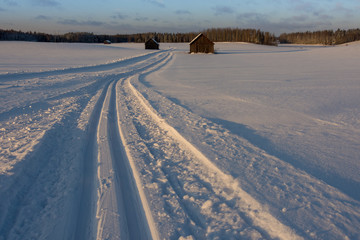 Old barns in snowy field