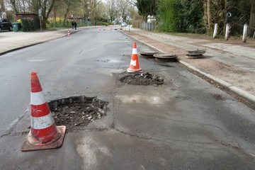 Road construction, road rehabilitation, asphalting. Holes and damage on an asphalt road, secured by...