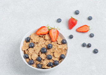 Multigrain wholewheat healthy cereals with fresh berries strawberries and blueberries. Healthy breakfast.