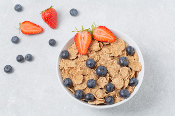 Multigrain wholewheat healthy cereals with fresh berries strawberries and blueberries. Healthy breakfast.